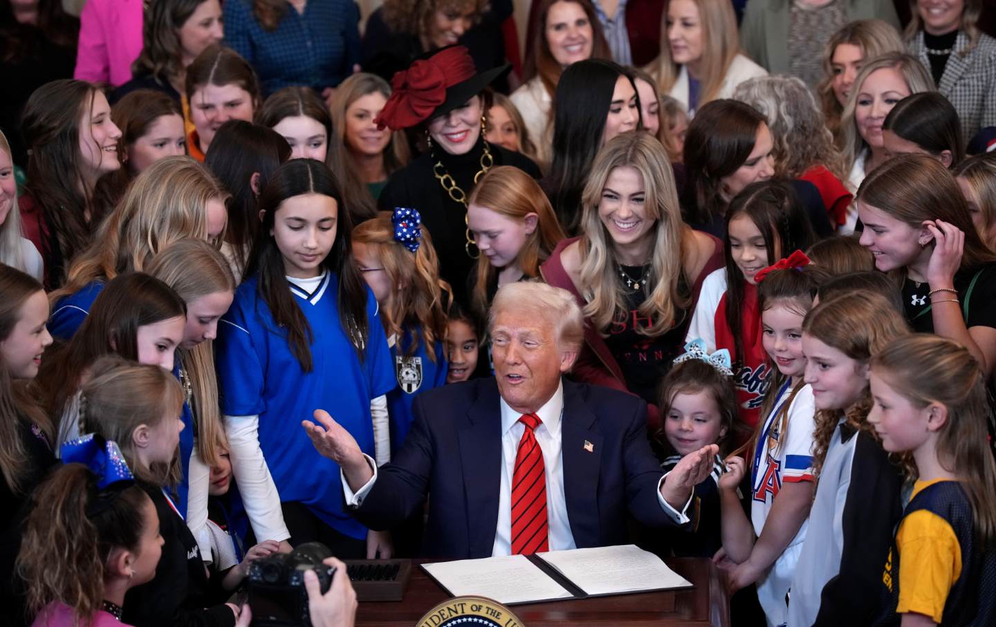 Donald Trump joined by women athletes signs the “No Men in Women’s Sports” executive order in the East Room at the White House on February 5, 2025